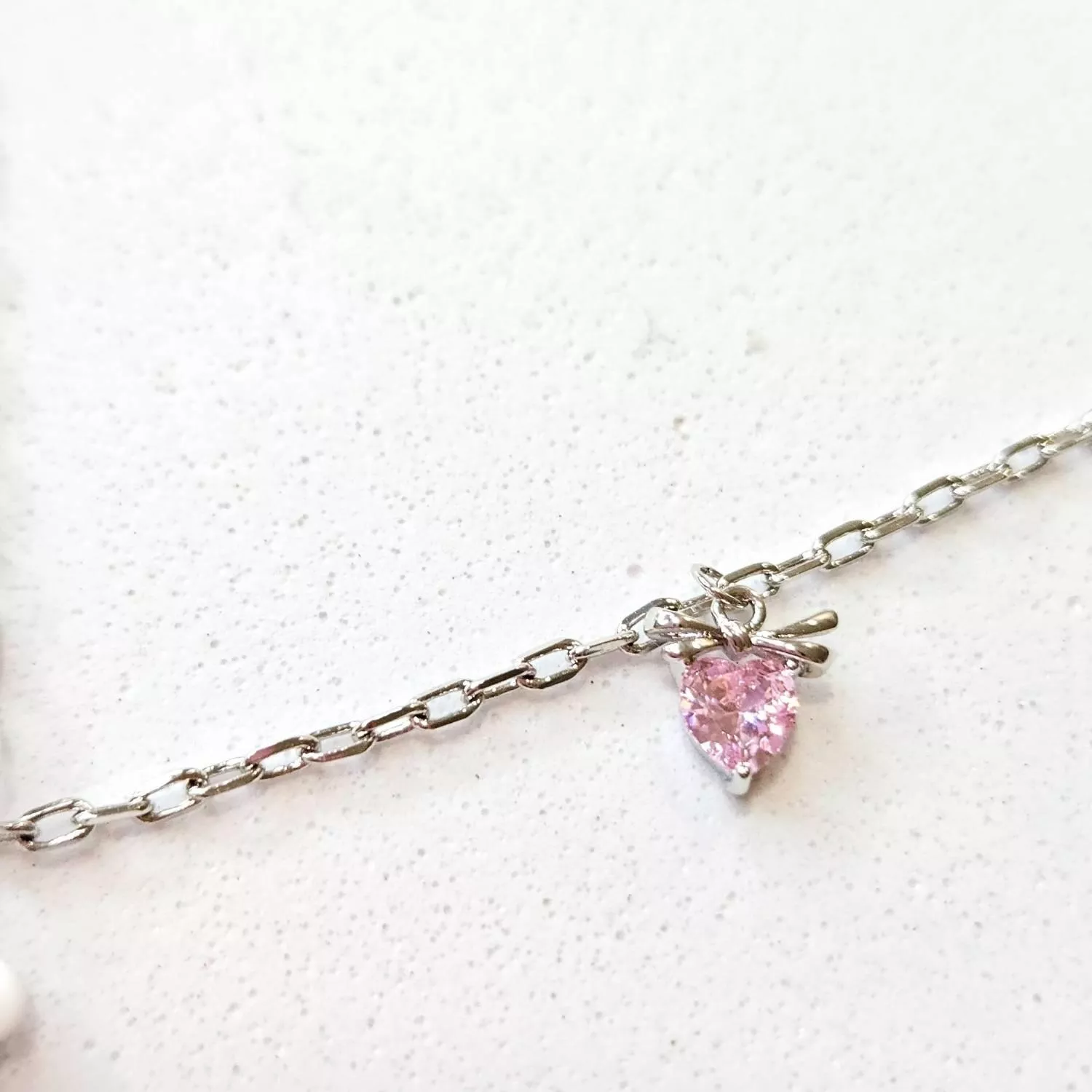 潔白瑩潤的小熊懷抱著一顆粉色璀璨愛心 像是守護著心底最純真的夢想 細緻的銀色鍊條搭配點綴的星芒與墜飾 在頸間閃耀著動人的純真光芒  ✨ 商品亮點 立體小熊造型，俏皮可愛 粉色心形主石，閃耀立體光澤 精緻吊墜裝飾，層次豐富 抗氧化電鍍，佩戴舒適  穿搭建議： 圓領T恤 / 甜美洋裝 / 針織衫 / 閨蜜穿搭 / 慶生約會  【商品資訊】 ．鍊條材質 ：低敏S925銀 ．商品材質 ：鋯石(蘇聯鑽) ．Size 尺寸 ：56 cm (外加延長鏈4cm)