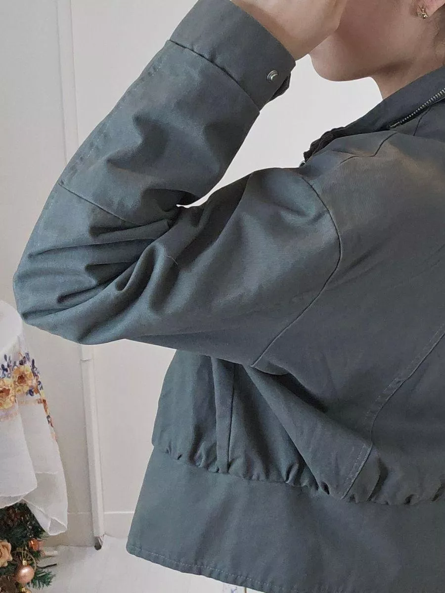 《灰影旅途》工裝立領短版夾克外套 &mdash;&mdash; 在城市的喧囂中，展開一場隨興而自由的風格冒險。 &mdash;&mdash;  【設計細節：剛柔並濟的靈魂】 =克將經典的工裝元素與現代短版廓形完美結合。 沈穩的軍綠色調（灰影綠）自帶一種不費力的時髦感，搭配領口與前襟精緻的金屬圓扣設計，在帥氣之中注入了細膩的質感。 不論是隨意敞開領口，或是全扣後的立領穿法，都能展現不同的層次張力。  【產品亮點】 黃金比例短版剪裁：短版設計，能視覺上拉高腰線，比例更顯挑高。 舒適落肩闊型： 不挑身形，消除了肩膀的沈重感，內搭厚實針織衫也依然俐落。 機能質感面料： 採用具挺度的布料，穿上即顯挺括有神，不易皺好打理，是旅途中最可靠的穿搭夥伴。  【穿搭靈感】 個性混搭： 內搭柔美的針織毛衣，運用針織與工裝布料的「剛柔對比」，層次感十足。 街頭運動： 搭配高腰寬褲與白布鞋，輕鬆穿出帥氣又顯腿長的街頭時髦。